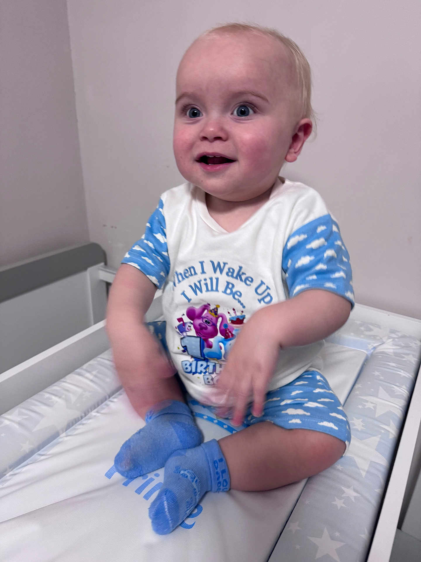 Thomas-Lee joined the competition — help win amazing prizes! baby, child, smiling, pajamas, blue, white, socks, changing_table, indoor, happy, portrait, infant, clothing, cute, small_hands, face, seated, expression, celebration, birthday