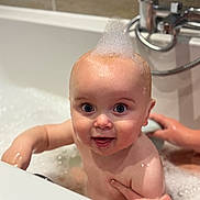 Thomas-Lee is registered to the contest to win money with this photo: baby, child, bath, bathtub, bubbles, foam, water, skin, hand, smile, happy, cute, indoor, person, head, face, eyes, fun, play, parent