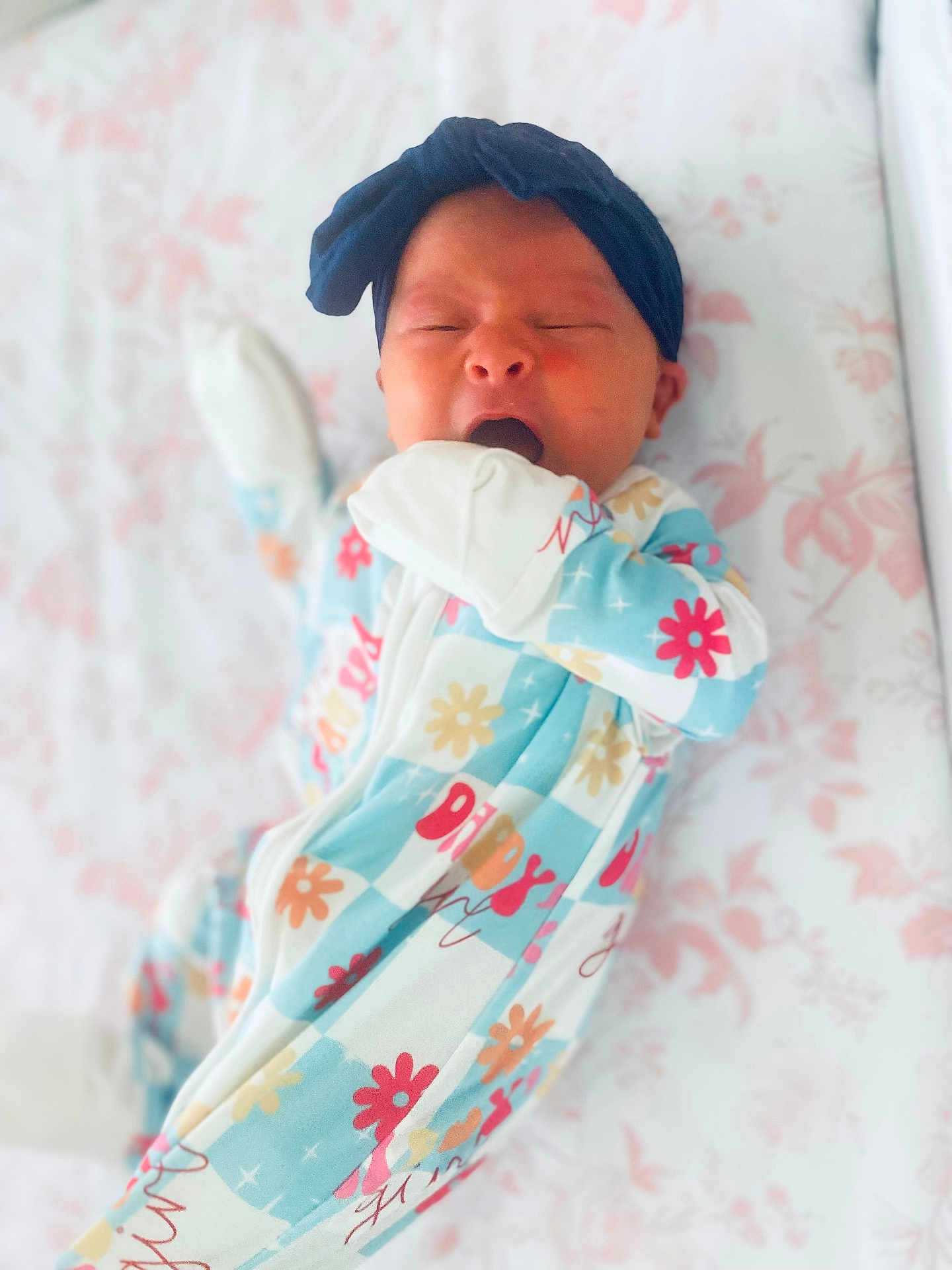 Blaire joined the competition — help win amazing prizes! baby, sleeping, yawning, headband, onesie, floral_pattern, infant, cute, bed, blanket, soft, newborn, child, sleepwear, hand, mouth, face, lying_down, pastel_colors, cozy