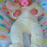 Kehlani is registered to the contest to win money with this photo: baby, baby_clothing, baby_seat, bonnet, bright_starts, carpet, child, colorful_background, comfort, cute, indoors, infant, pacifier, plush_toy, relaxed, sitting, smiling_face, soft_toys, toddler, yellow_onesie