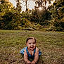 baby, child, grass, outdoor, nature, sunlight, trees, greenery, smiling, crawling, blue_clothing, happy, infant, summer, cute, portrait, daylight, playful, young_child, sunflare