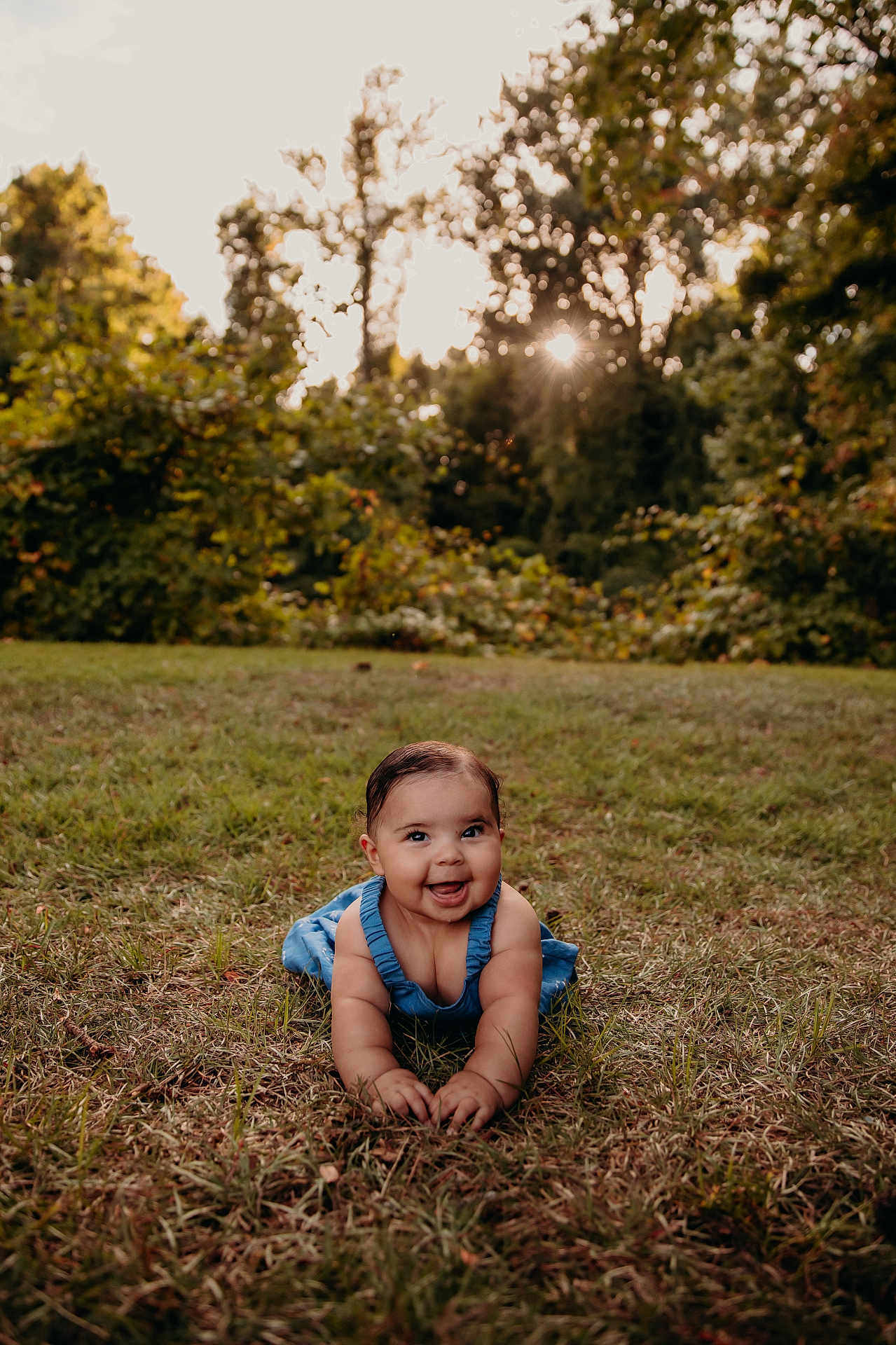 Kaya joined the competition — help win amazing prizes! baby, child, grass, outdoor, nature, sunlight, trees, greenery, smiling, crawling, blue_clothing, happy, infant, summer, cute, portrait, daylight, playful, young_child, sunflare