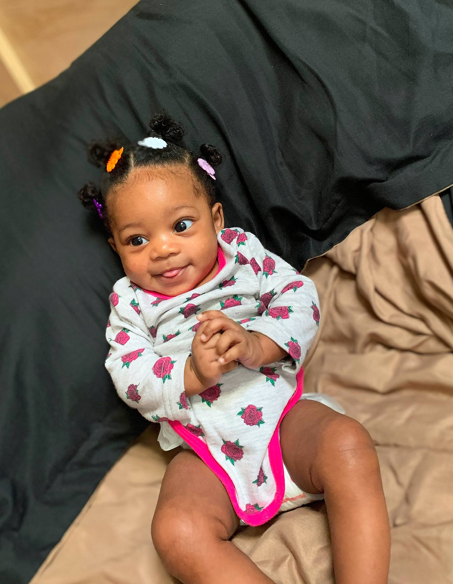 Karlie is registered to the contest to win money with this photo: baby, baby_products, baby_toddler_clothing, black_hair, cheek, child, finger, joy, lip, person, pink, sitting, toddler