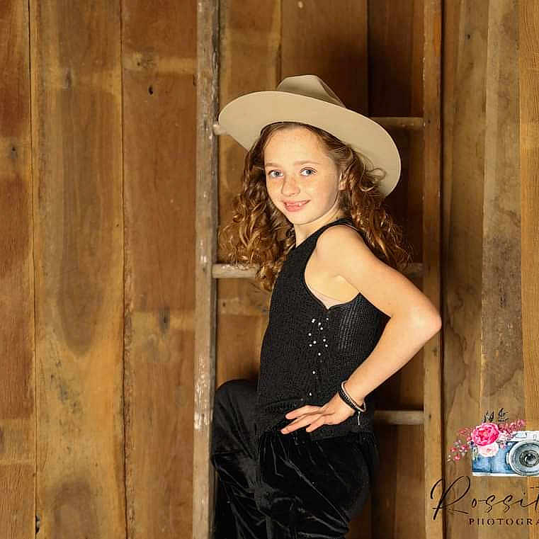 Alania joined the competition — help win amazing prizes! adult, blonde, clothing, dress, eveningdress, face, fashion, female, formalwear, hair, happy, hat, head, person, photobooth, photography, portrait, suit, woman, wood