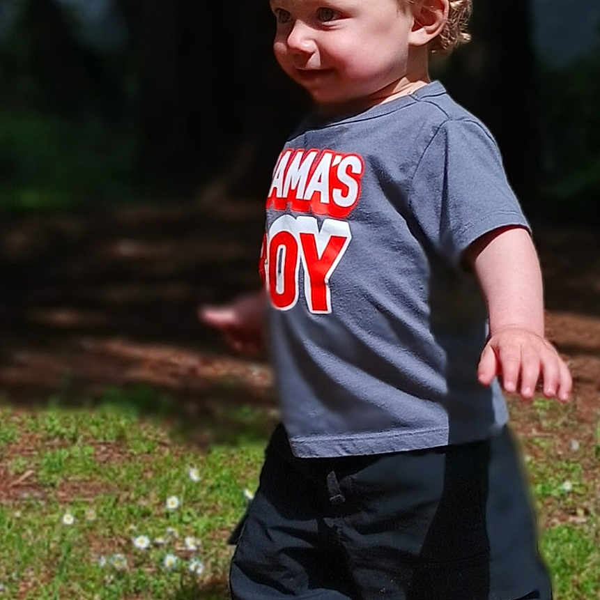Raiden Kyng Bergeson joined the competition — help win amazing prizes! boy, child, clothing, cute, daylight, forest, grass, happy, nature, orange_crocs, outdoor, person, shadow, shirt, shoes, smile, sunlight, toddler, trees, walking
