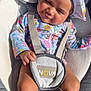 baby, child, infant, sunhat, floral_clothing, seat, straps, cushion, sunlight, skin, legs, hand, outdoor, cute, expression, portrait, summer, colorful, comfort, resting