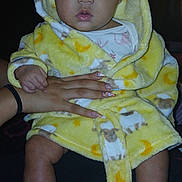 Hennessey joined the competition — help win amazing prizes! baby, bottle, child, cute, fuzzy_slippers, hand, holding, indoor, infant, manicured_nails, moon_pattern, person, portrait, robe, sheep_pattern, soft_fabric, surprised_expression, warm_clothing, wide_eyes, yellow