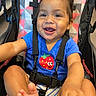 Ava joined the competition — help win amazing prizes! baby, blue_shirt, casual_clothing, child, colorful, cute, face, feet, hands, happy, indoor, person, playful, portrait, seatbelt, smiling, strawberry_graphic, stroller, toddler, young_child