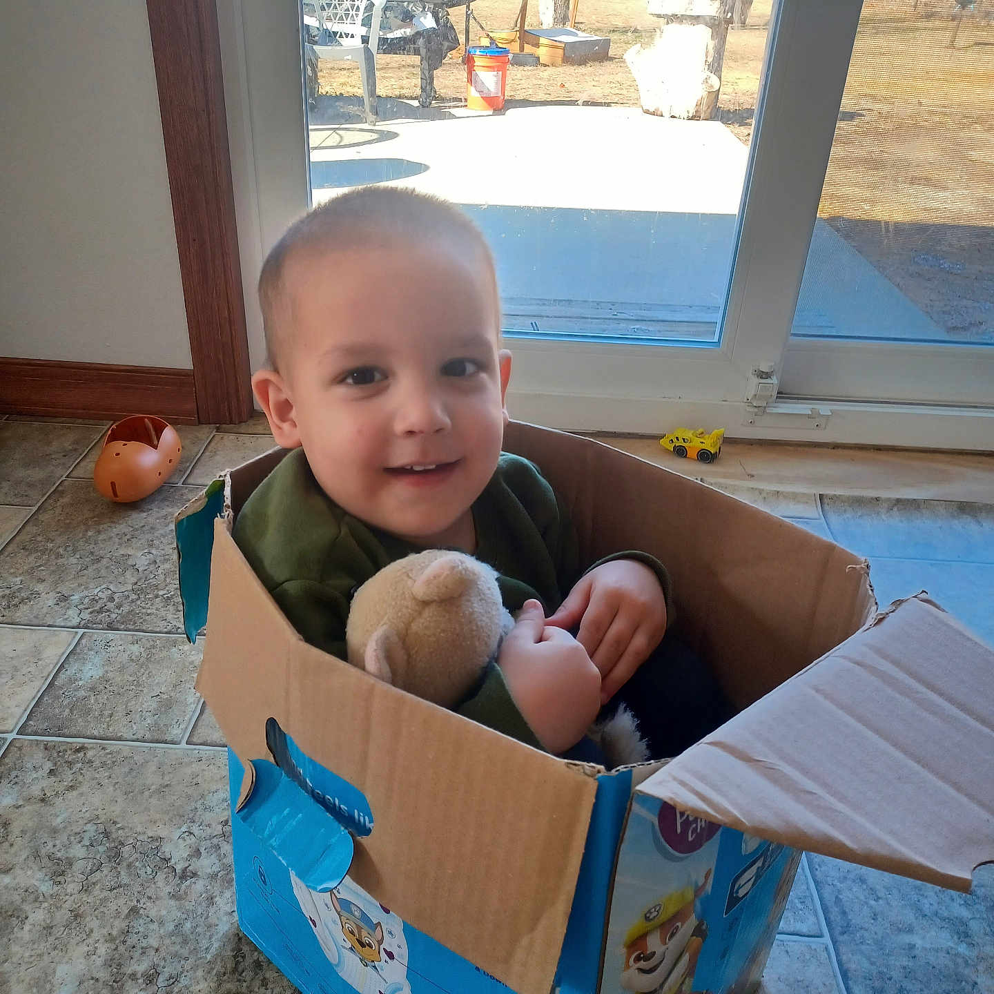 Everett is registered to the contest to win money with this photo: baby, box, car, cardboard, carton, chair, door, face, furniture, head, helmet, person, photography, plant, portrait, pottedplant, toy, transportation, vehicle, wood