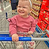 toddler, child, shopping_cart, supermarket, smiling, girl, bow, headband, clothing, pink_sweater, floral_pants, aisle, products, candid, happy, person, retail, store, holding, shopping