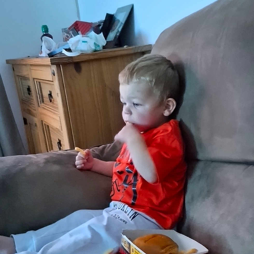 Lincoln Webster is registered to the contest to win money with this photo: architecture, baby, bodypart, building, couch, cushion, face, finger, furniture, hand, head, homedecor, indoors, interiordesign, livingroom, person, photography, portrait, room, sitting