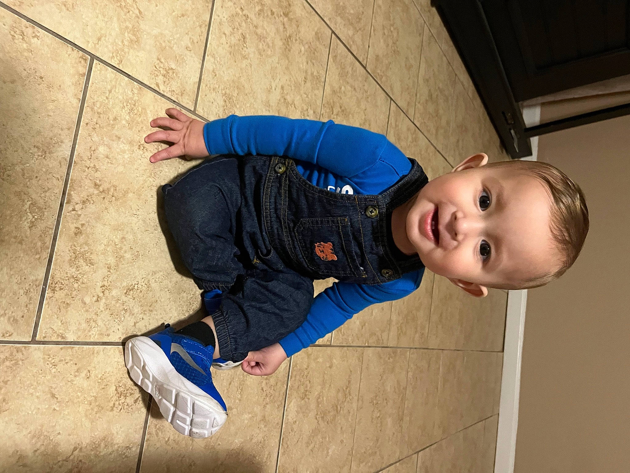 Noah is registered to the contest to win money with this photo: baby, child, concrete, denim, electric_blue, flash_photography, flooring, fun, happy, jacket, leisure, pattern, person, play, road_surface, sidewalk, sitting, smile, toddler