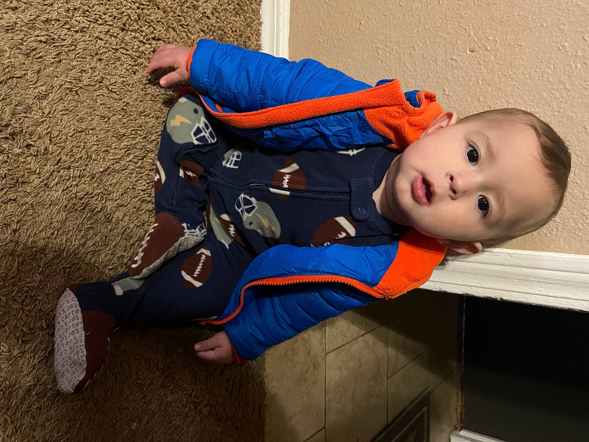 Noah is registered to the contest to win money with this photo: baby, baby_toddler_clothing, carmine, child, comfort, costume, elbow, electric_blue, foot, fun, hat, human_leg, knee, leg, pattern, person, sitting, sleeve, surprise, thigh