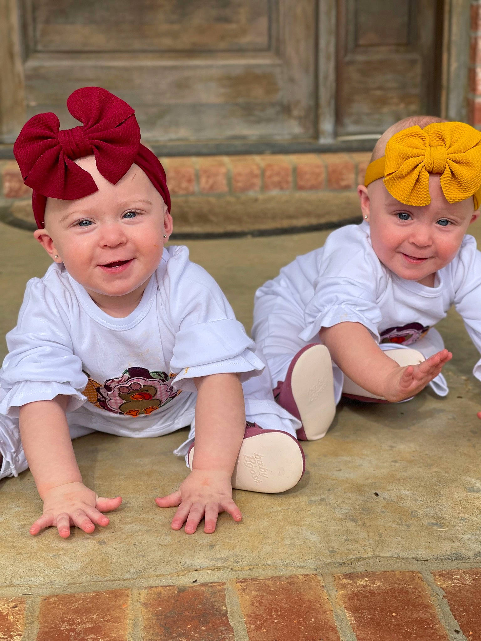 Mia And Mya joined the competition — help win amazing prizes! baby_toddler_clothing, cap, child, flooring, foot, fun, grass, happy, hat, headgear, headwear, joy, leg, leisure, mouth, person, plant, red, sitting, smile
