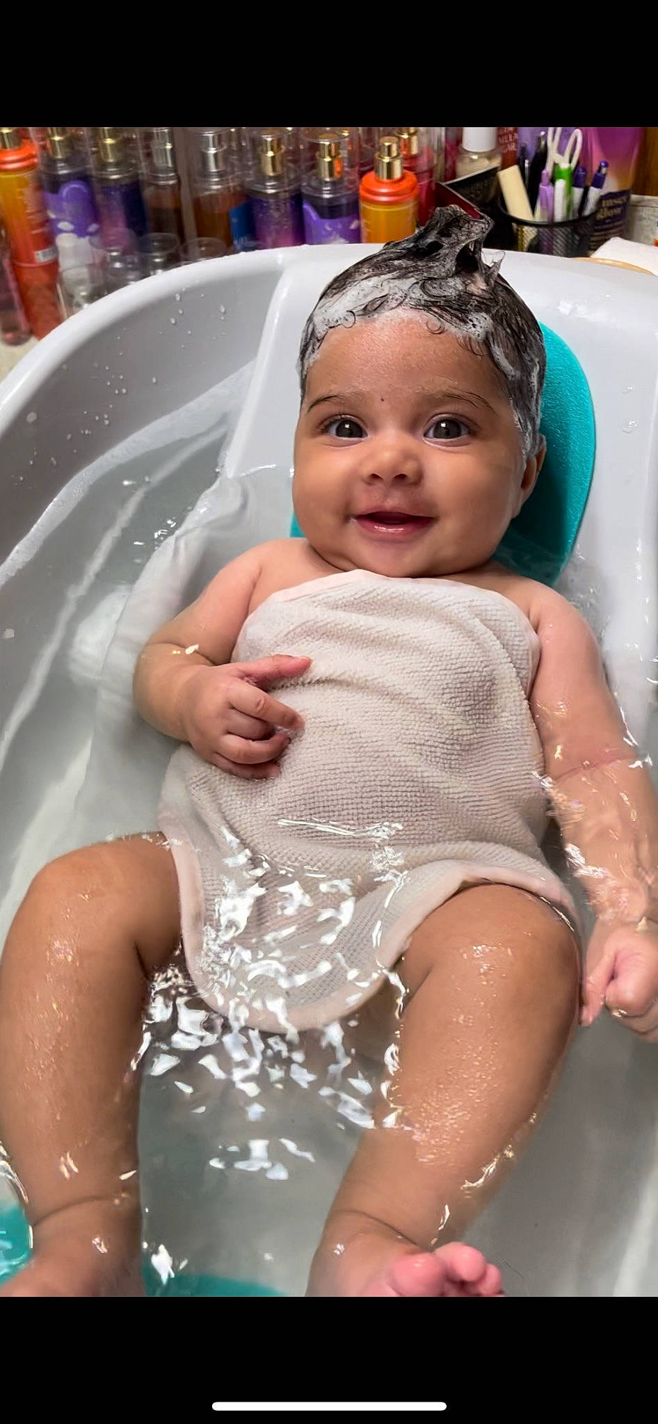 Londyn is registered to the contest to win money with this photo: bathing, dress, eye, facial_expression, fun, hair, hairstyle, happy, head, headwear, human_body, leisure, organ, person, photograph, pink, product, skin, smile, toddler