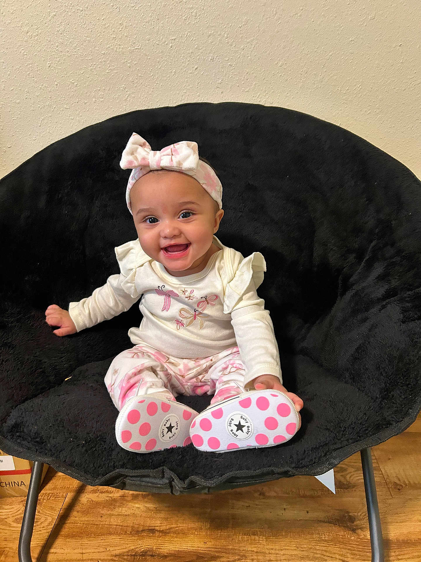 Ivory joined the competition — help win amazing prizes! baby, child, smiling, headband, bow, sitting, chair, black_chair, long_sleeve, patterned_pants, pink, white, shoes, polka_dots, floor, wood_floor, indoor, happy, cute, portrait