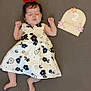 baby, infant, child, dress, red_bow, flower_pattern, sleeping, lying_down, 2_months, decorative_sign, pink_flowers, orange_flowers, gray_background, cute, peaceful, small_hands, small_feet, portrait, indoor, adorable