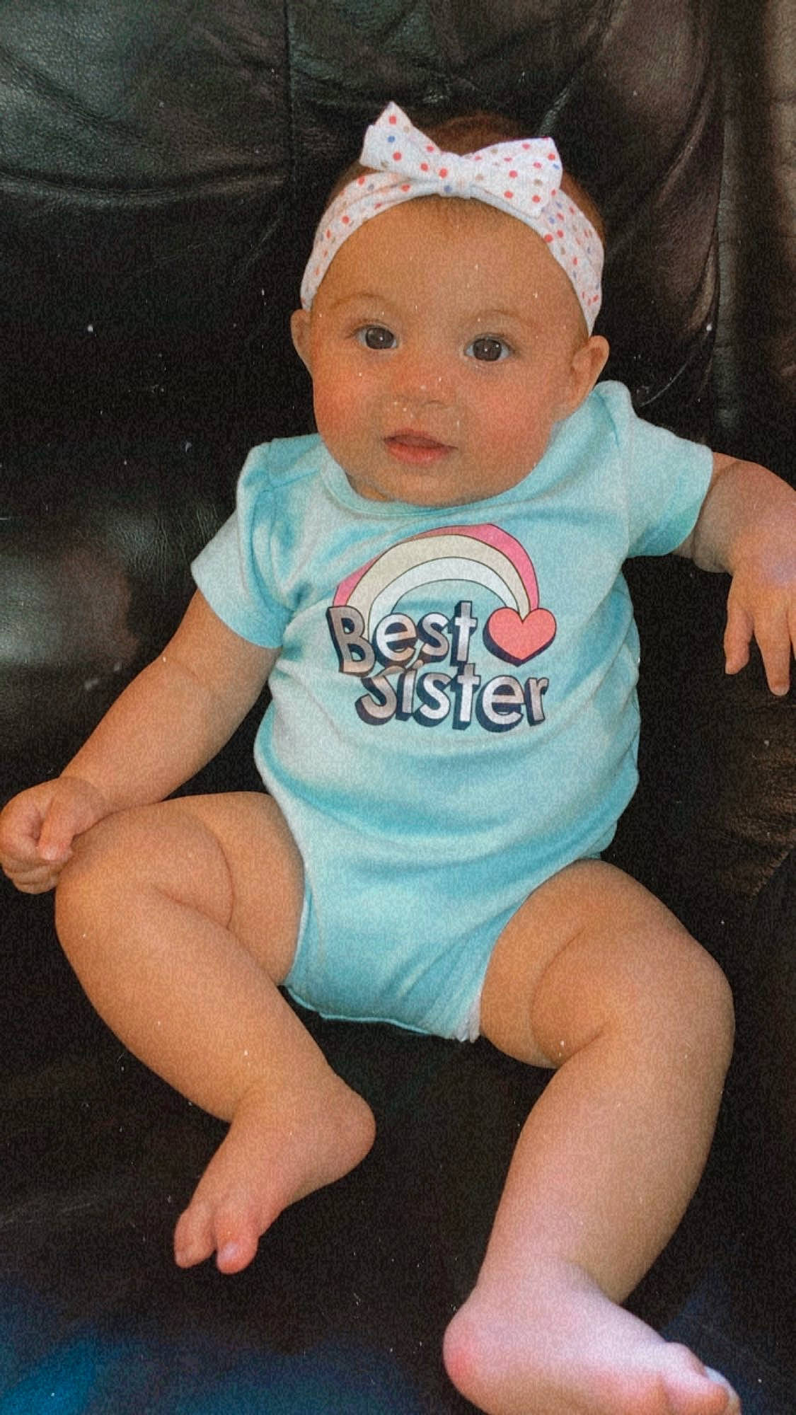 Madison is registered to the contest to win money with this photo: baby, baby_products, baby_toddler_clothing, blue, cheek, child, diaper, hair_accessory, headgear, person, product, sitting, skin, t_shirt, toddler, turquoise