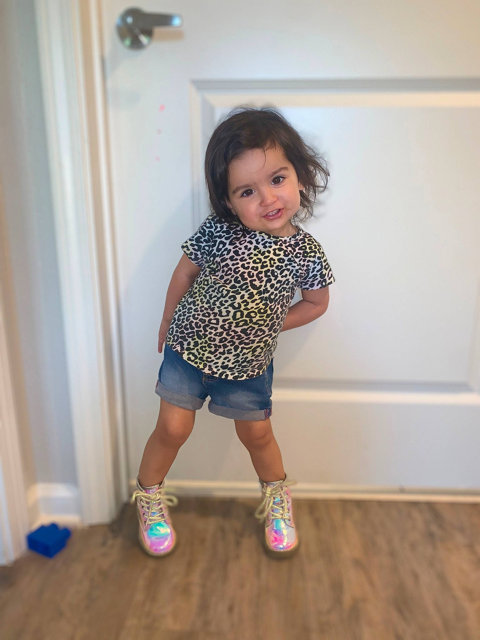 Laylah is registered to the contest to win money with this photo: baby_toddler_clothing, child, door, electric_blue, flooring, fun, happy, hardwood, human_leg, knee, pattern, person, shorts, sleeve, sock, thigh, toddler, varnish, wood, wood_flooring