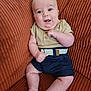 baby, infant, smile, sitting, couch, clothing, shorts, polo_shirt, belt, barefoot, indoors, cute, chubby, face, child, furniture, happy, skin, person, portrait