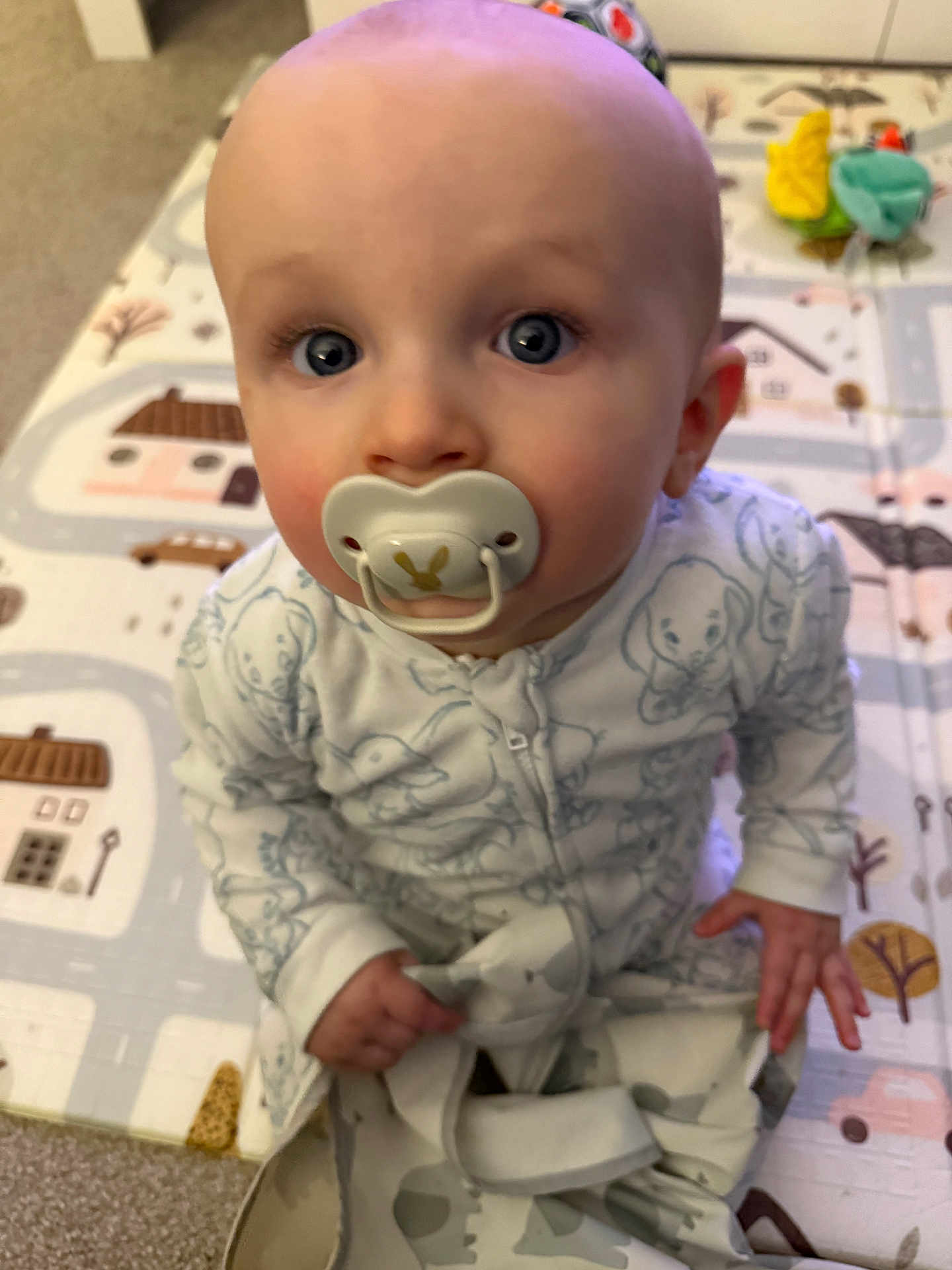 Niall joined the competition — help win amazing prizes! baby, pacifier, pajamas, child, indoor, playmat, blue_eyes, sitting, infant, cute, carpet, toy, patterned_clothing, hands, face, head, young_child, floor, home, curious