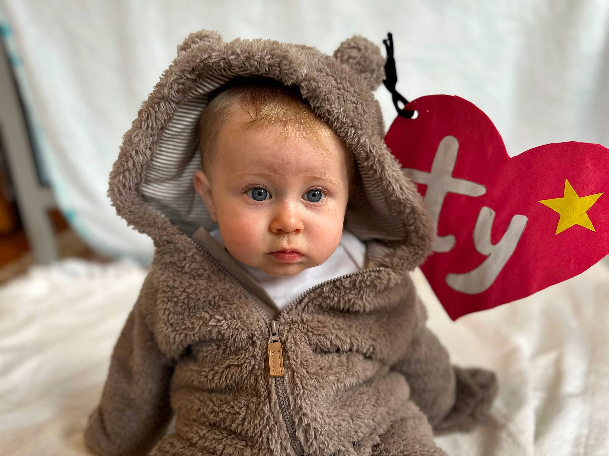 Logan joined the competition — help win amazing prizes! baby, baby_toddler_clothing, cap, cheek, child, comfort, costume_hat, eye, fashion_accessory, fun, fur, happy, hood, organ, person, skin, sleeve, textile, toddler, winter