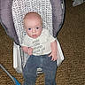 baby, infant, child, baby_seat, clothing, shirt, carpet, indoor, person, cute, expression, seat, pattern, blue_eyes, pants, footwear, hand, face, young, curious