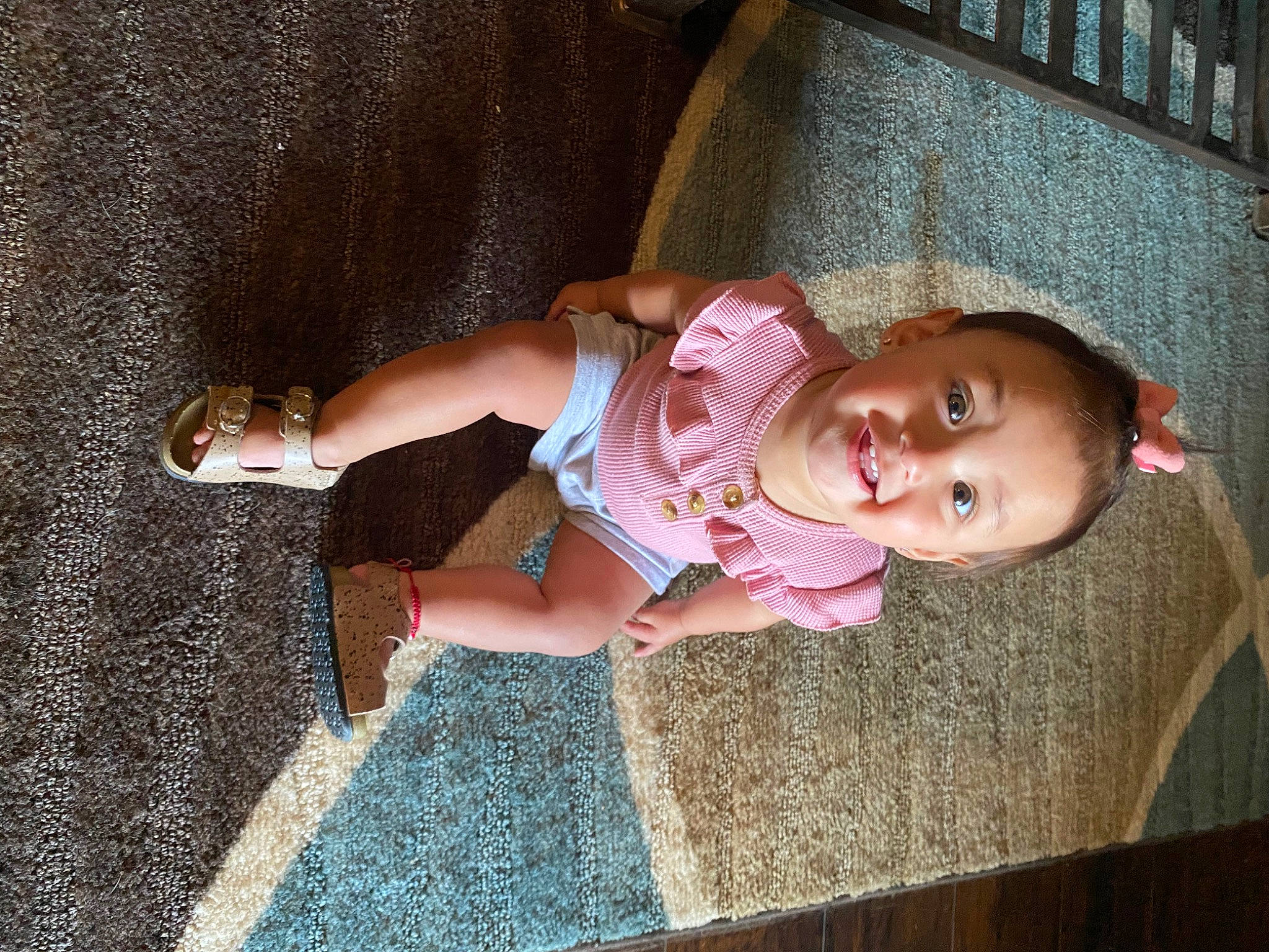Evelyn is registered to the contest to win money with this photo: baby, baby_toddler_clothing, child, dress, finger, flooring, foot, fun, happy, human_body, human_leg, joy, leg, mouth, person, pink, skin, smile, temple, thigh