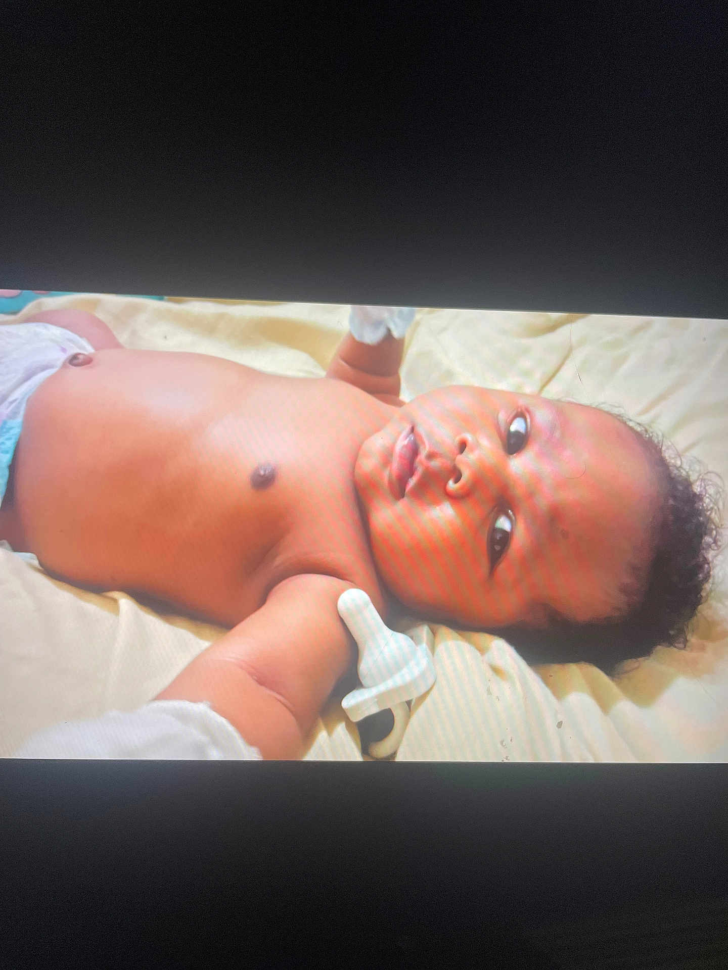 Brandon joined the competition — help win amazing prizes! baby, infant, diaper, mittens, blanket, lying_down, face, skin, cute, child, portrait, young, person, expression, indoors, soft_light, head, curly_hair, resting, newborn