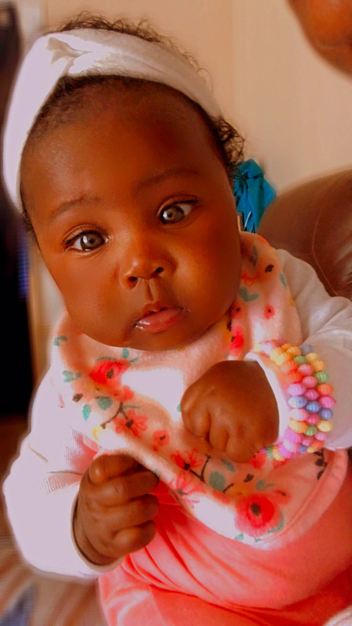 Raven is registered to the contest to win money with this photo: baby, baby_toddler_clothing, cheek, chin, dress, eye, eyelash, face, facial_expression, hand, head, human, human_body, iris, lip, mouth, neck, nose, organ, person