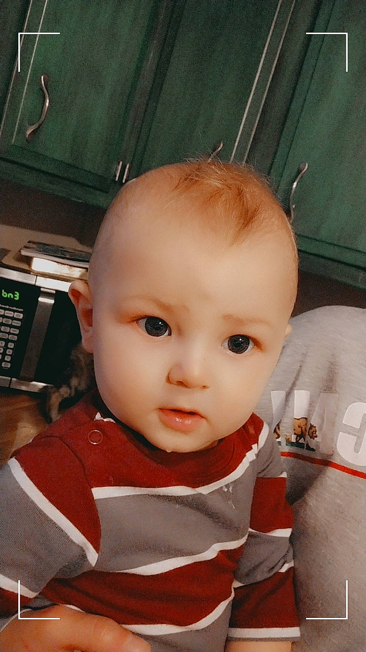 John is registered to the contest to win money with this photo: baby, baby_toddler_clothing, carmine, cheek, child, chin, cool, eye, eyebrow, eyelash, fun, gas, nose, person, sitting, skin, sleeve, toddler