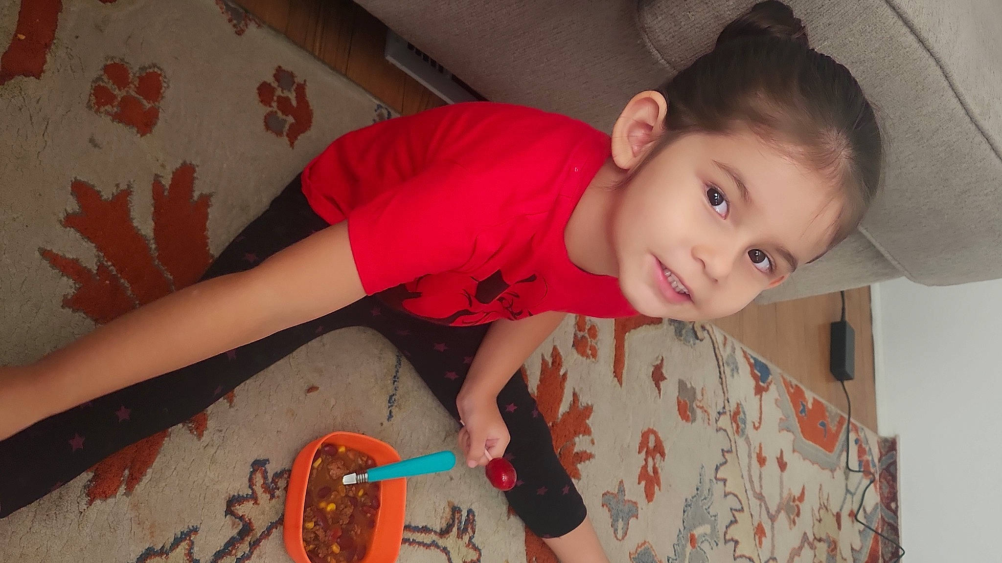 Amira is registered to the contest to win money with this photo: baby, baby_toddler_clothing, child, finger, floor, flooring, fun, happy, human_leg, joy, mouth, nose, pattern, person, skin, sleeve, smile, t_shirt, tableware, thigh