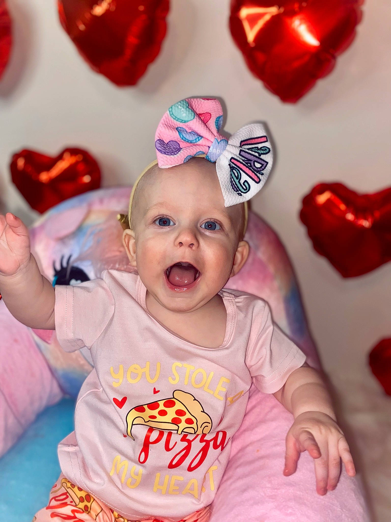 Lorelai is registered to the contest to win money with this photo: baby, baby_toddler_clothing, cap, child, costume_hat, event, facial_expression, fun, happy, magenta, organ, person, pink, product, red, sleeve, smile, t_shirt, textile, toddler
