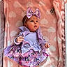 baby, infant, child, purple_dress, butterfly_pattern, headband, bow, blanket, pink, hearts, soft_texture, cute, lying_down, indoors, newborn, small_hands, curious_look, colorful_clothing, adorable, portrait