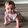 baby, infant, crawling, floor, wooden_floor, dress, floral_pattern, cute, child, indoors, person, smiling, happy, young, skin, hands, eyes, short_hair, playful, portrait