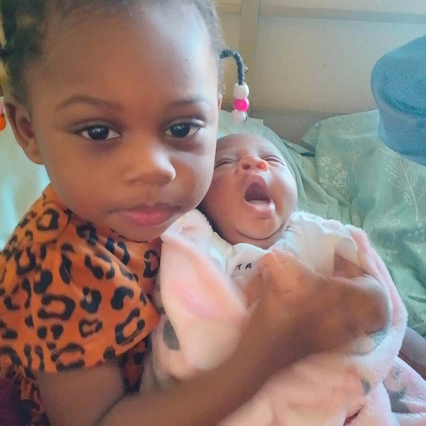 Elijah'Nae joined the competition — help win amazing prizes! toddler, baby, child, indoor, blanket, holding, yawning, portrait, cute, person, bed, pillow, clothing, pink, animal_print, hair_beads, infant, sibling, family, cozy