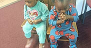 Elijah'Nae joined the competition — help win amazing prizes! child, toddler, two_children, sitting, chairs, indoor, carpet, wooden_chair, blue_clothing, turquoise_clothing, princess_design, spiderman_design, sneakers, braided_hair, curly_hair, hands_clasped, flooring, wall, playful, cute