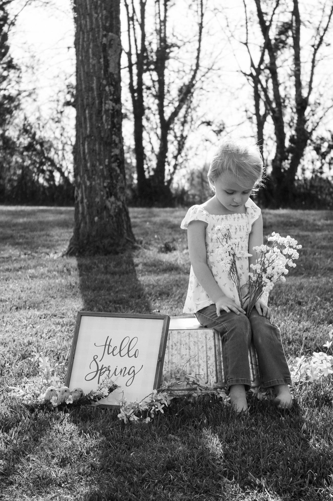Avery Alizabeth is registered to the contest to win money with this photo: black_and_white, child, flower, forest, grass, happy, lawn, leaf, monochrome, monochrome_photography, people_in_nature, person, plant, sitting, sky, standing, style, sunlight, tints_and_shades, toddler