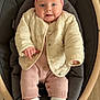 baby, infant, headband, bow, pink_headband, puffer_jacket, knit_suit, baby_shoes, sneakers, socks, baby_seat, rocker, wooden_frame, hardwood_floor, smiling, face, eyes, hands, cozy, portrait