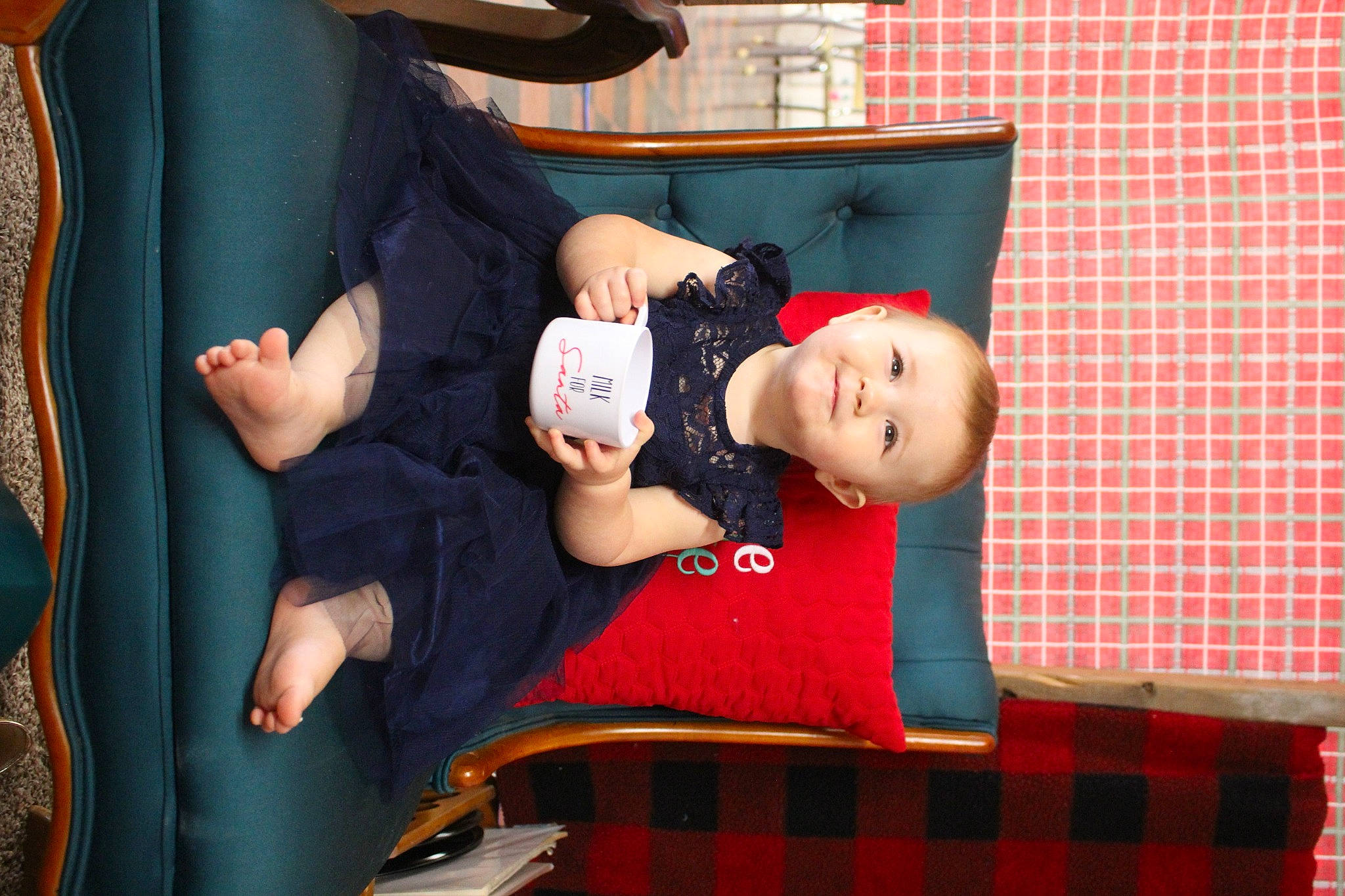 Meredith is registered to the contest to win money with this photo: baby, child, comfort, event, fun, happy, human_body, joy, lap, leg, pattern, person, plaid, red, room, sitting, sock, tartan, textile, thigh