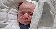 Owen joined the competition — help win amazing prizes! baby, baby_seat, blanket, closeup, clothing, cozy, cushion, face, head, indoors, infant, lamp, newborn, peaceful, portrait, resting, sleeping, soft, wooden_floor, wrapped