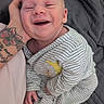 Owen is registered to the contest to win money with this photo: baby, smiling, striped_pajamas, koala_slippers, tattooed_hand, hand, bed, blanket, infant, cute, happy, person, child, sleepwear, cozy, portrait, indoor, relaxed, closeup, comfort