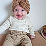 baby, child, smiling, headband, knitted, bow, cream_clothing, corduroy_pants, sitting, indoors, happy, cute, portrait, face, blue_eyes, long_sleeves, infant, cozy, neutral_colors, texture