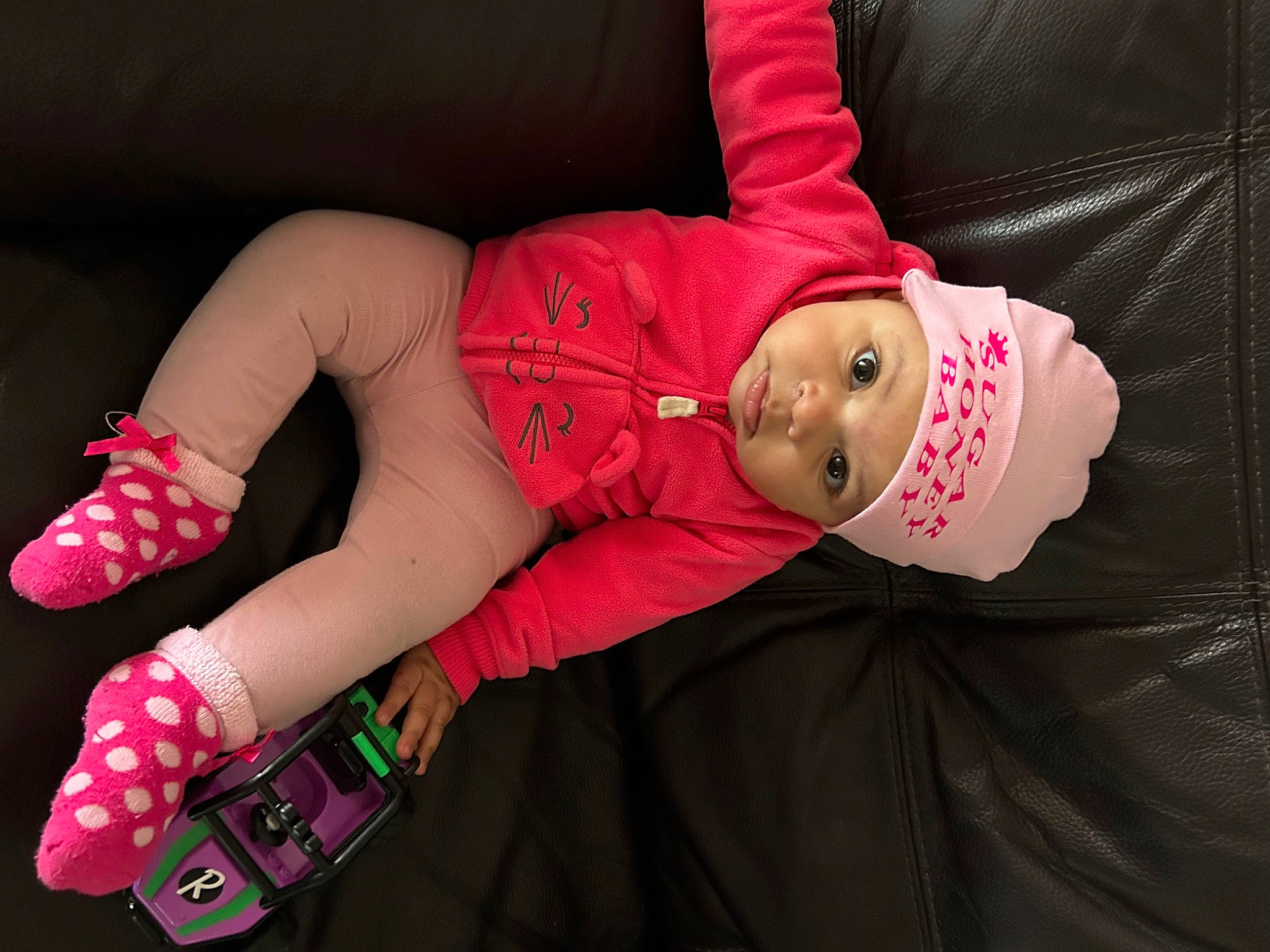 Isabella is registered to the contest to win money with this photo: carmine, costume_hat, doll, elbow, event, fashion_accessory, foot, hat, headwear, human_leg, knee, magenta, nail, pattern, person, pink, sleeve, sock, textile, thigh