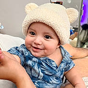 Nyjah is registered to the contest to win money with this photo: baby, child, infant, smiling, hat, bear_ears, blue_shirt, cute, portrait, indoors, person, happy, skin, face, hand, arm, clothing, baby_fashion, expression, human