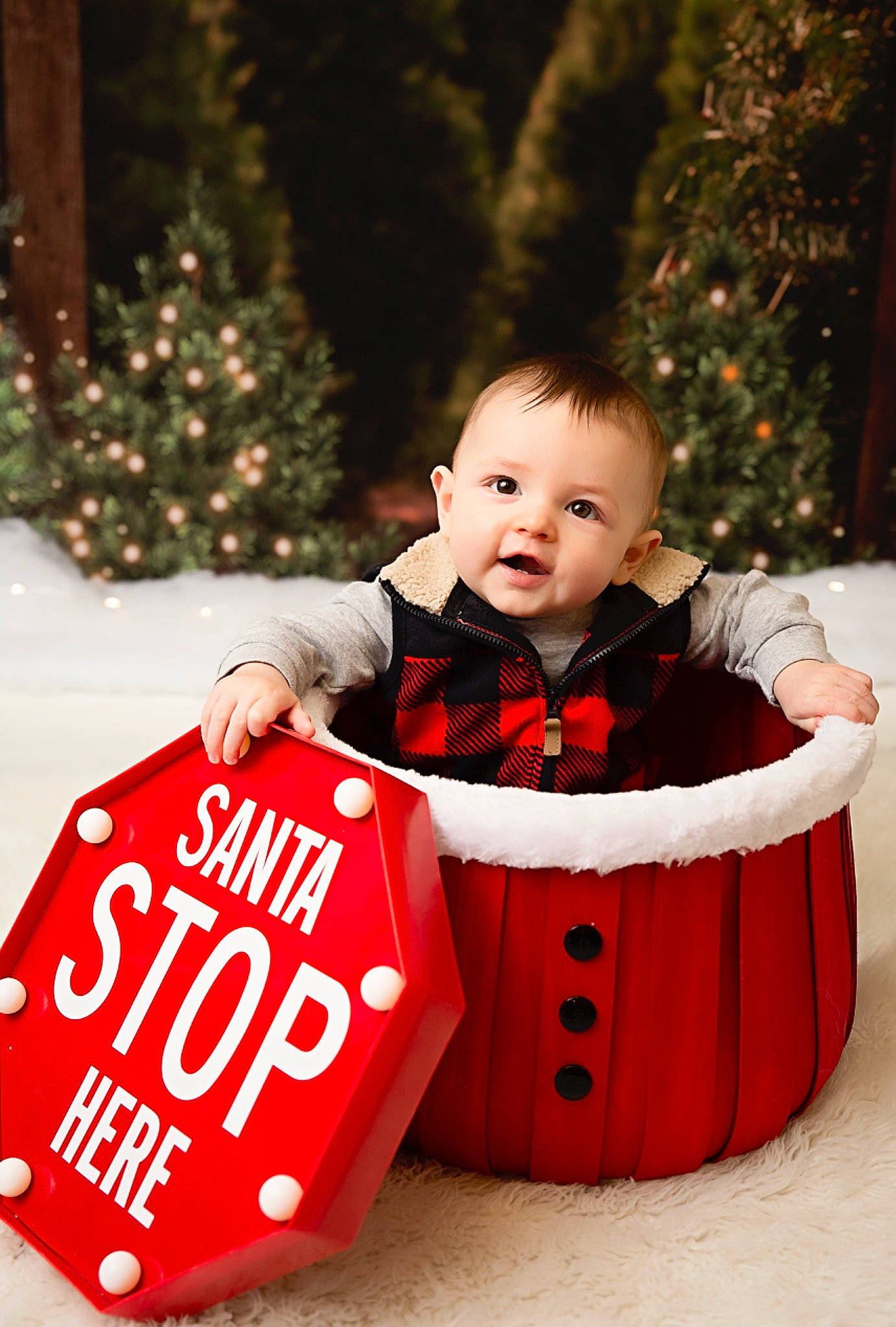Joseph is registered to the contest to win money with this photo: baby, baby_toddler_clothing, carmine, child, christmas, christmas_decoration, christmas_eve, christmas_ornament, christmas_tree, event, fun, happy, holiday, interior_design, person, portrait_photography, red, sitting, sleeve, smile