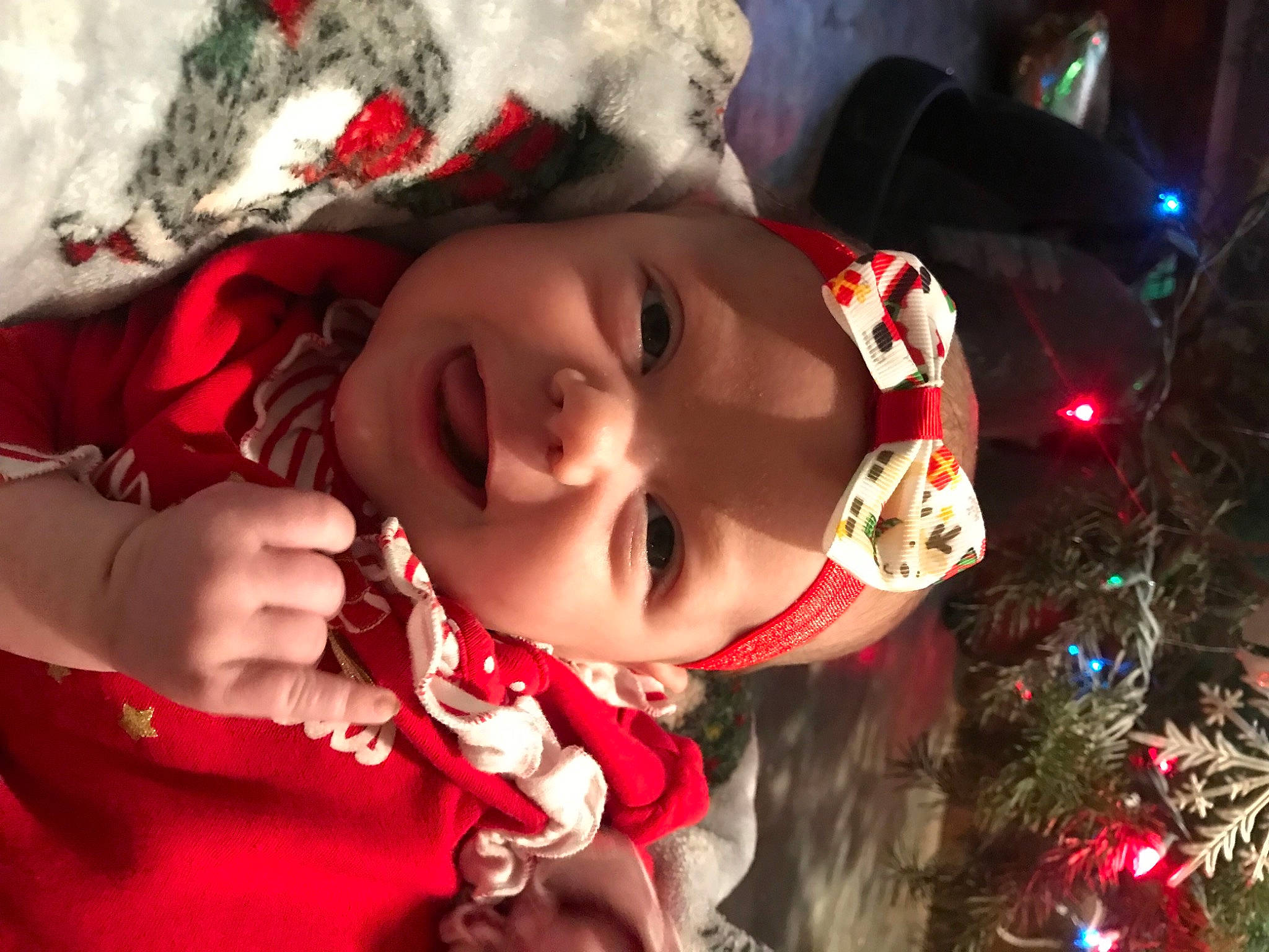Emberlyn joined the competition — help win amazing prizes! baby, black_hair, cheek, child, christmas_tree, event, fun, happy, headwear, human_body, lip, mouth, nose, ornament, person, plant, red, smile, toddler, tradition