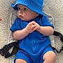 Isaac participe au concours pour gagner de l'argent avec cette photo : baby, blue_clothing, bucket_hat, infant, plush_cushion, straps, hand_gesture, curious_gaze, indoor, soft_texture, child, casual_outfit, seated, close_up, cute, portrait, skin, headwear, person, comfort