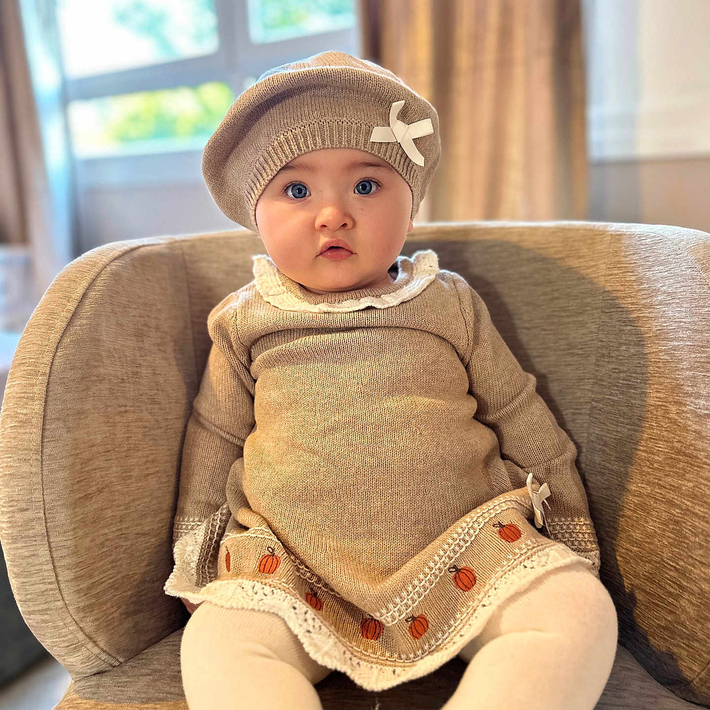 Nayvi is registered to the contest to win money with this photo: baby, beanie, bonnet, cap, chair, clothing, face, furniture, happy, hat, head, knitwear, pants, person, photography, portrait, sitting, sleeve, smile, sweater