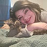 Louise is registered to the contest to win money with this photo: adult, animal, bed, blanket, cat, clothing, couch, face, female, furniture, head, kitten, knitwear, lamp, person, pet, photography, portrait, sweater, woman
